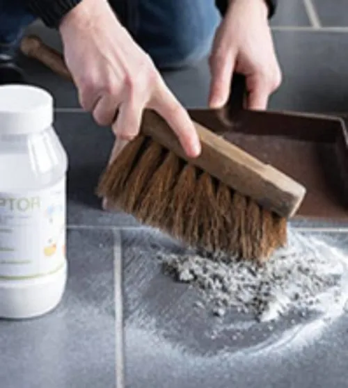 person cleaning the floor with polycaptor universal absorbent